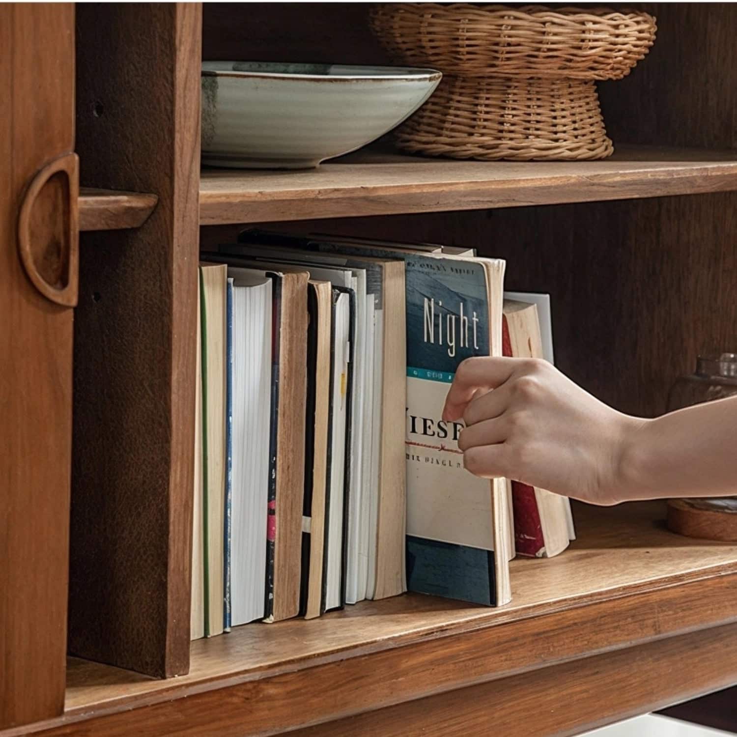 Hand pulling book from a
