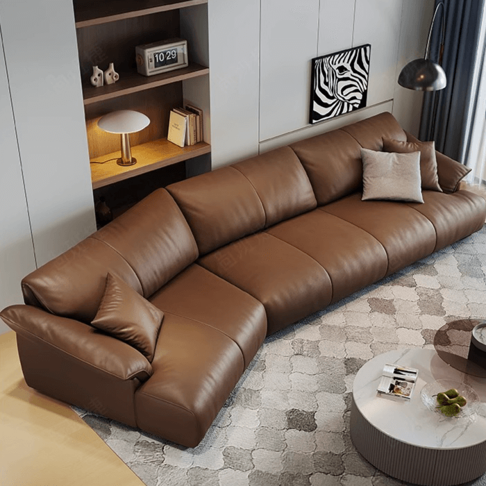 Brown leather curved sofa with